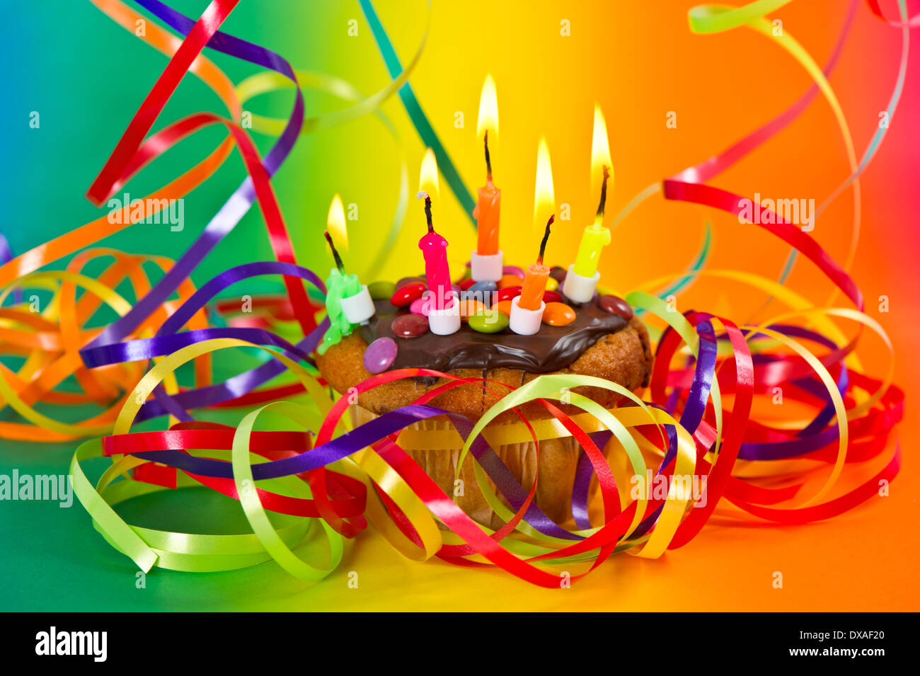 Birthday Cake With Colorful Streamer Decoration And Burning