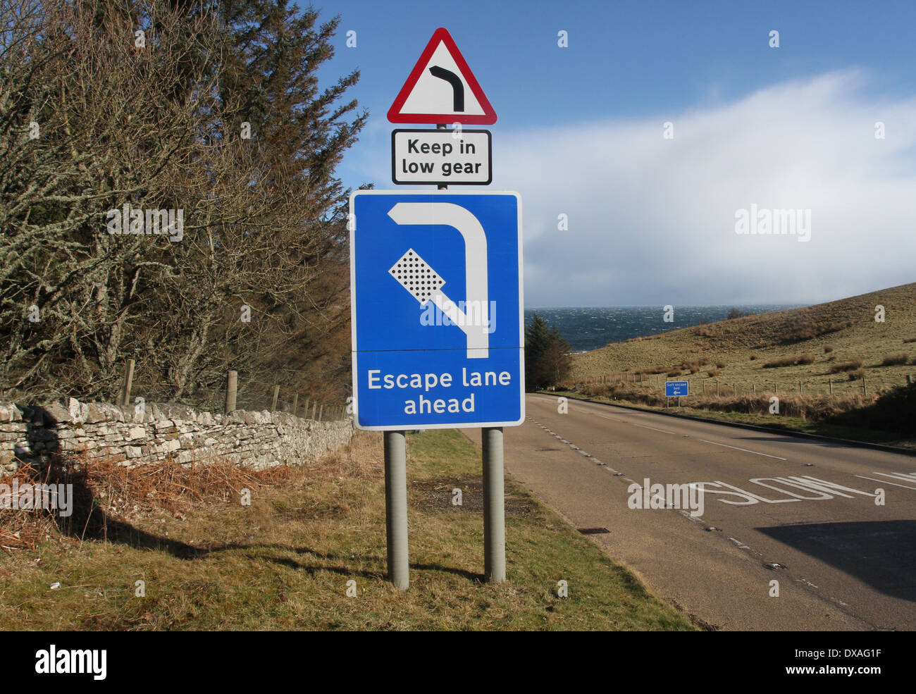 Sign for escape lane on steep hill on A9 near Berriedale Scotland Stock