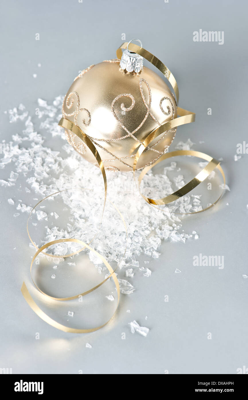 golden christmas ball with golden decoration and snow Stock Photo