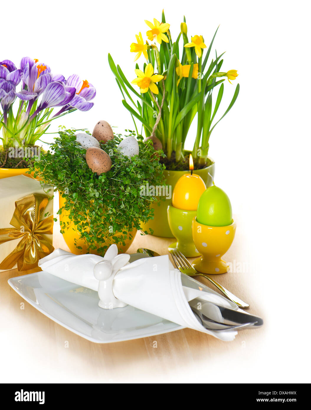 festive easter table setting with eggs and flowers decoration on white background Stock Photo