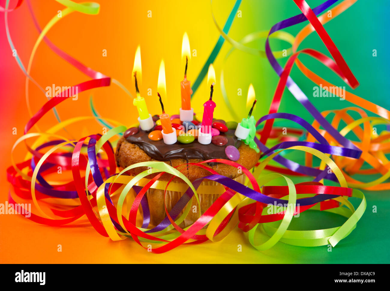 birthday cake with burning candles and colorful decoration Stock Photo ...