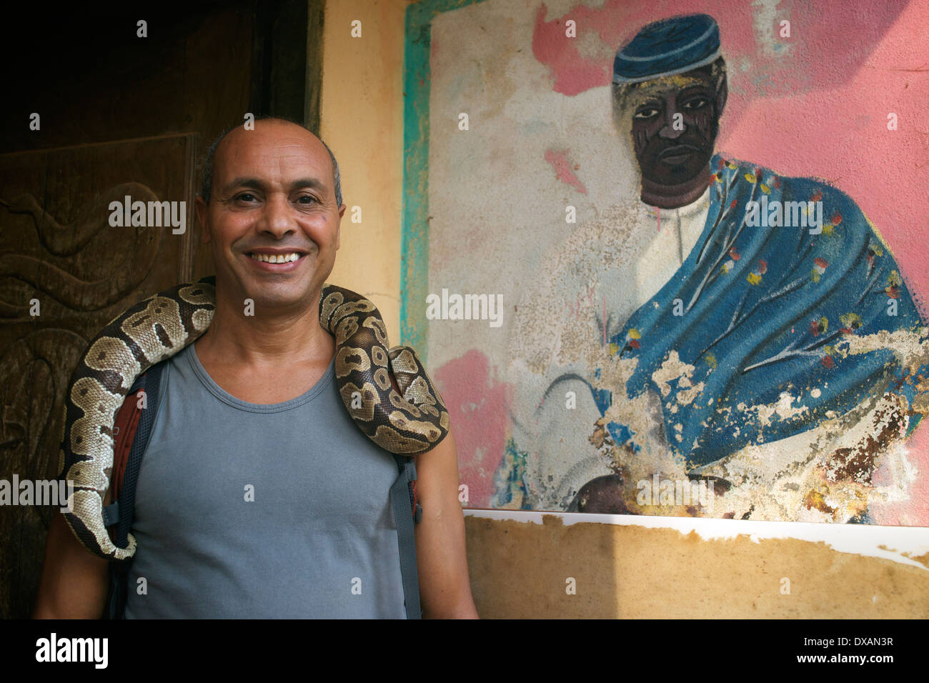 Tourist posing with a snake around his neck, Benin, West Africa Stock Photo