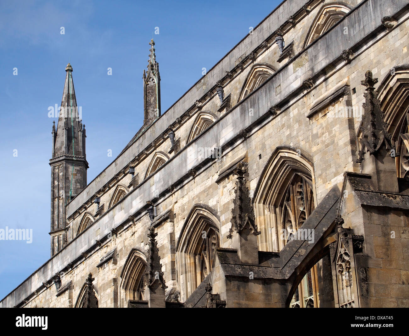 Perpendicular style medieval architecture showing windows and flying buttresses at Winchester Cathedral, Hampshire. Stock Photo