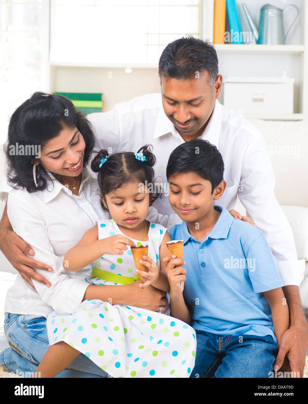 indian family enjoying eating ice cream indoor Stock Photo