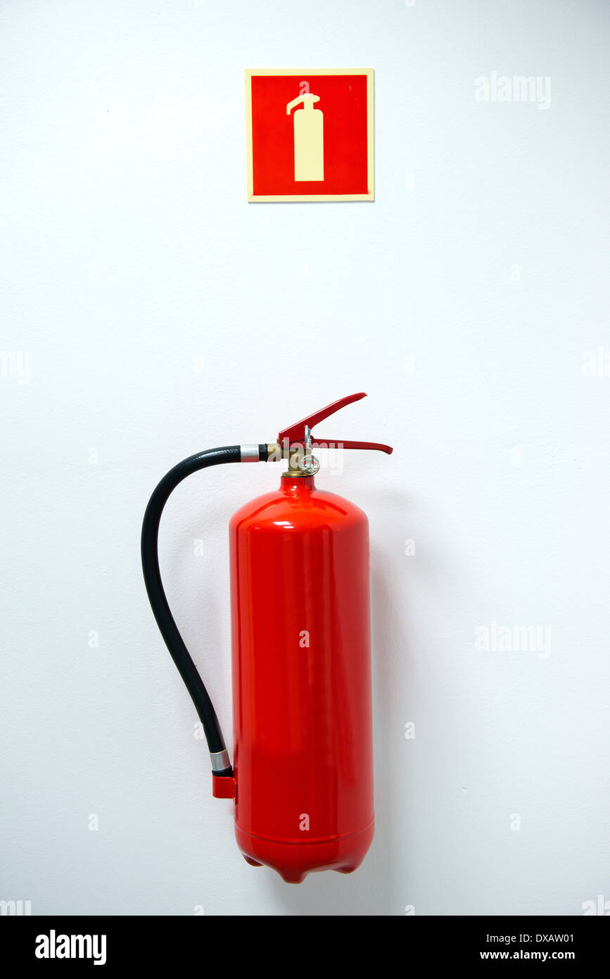 fire extinguisher and sign on the wall Stock Photo