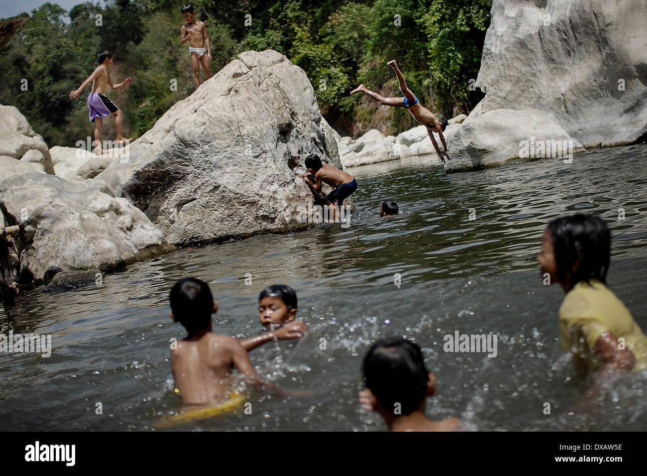 Rodriguez, Philippines. 22nd Mar, 2014. Children cool off in the river of the now defunct Wawa Dam water reservoir in Rodriguez town, Rizal province, Philippines, March 22, 2014. March 22 marks International World Water Day with this year's theme ''Water and Energy.''.Photo: Ezra Acayan/NurPhoto Credit:  Ezra Acayan/NurPhoto/ZUMAPRESS.com/Alamy Live News Stock Photo