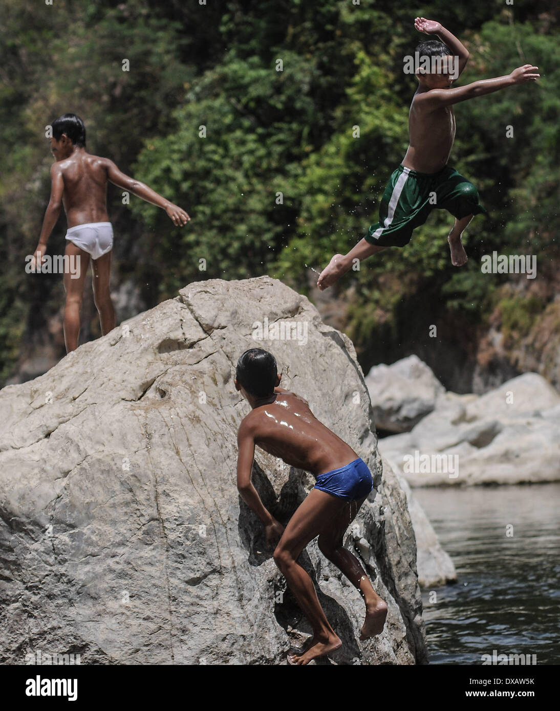Rodriguez, Philippines. 22nd Mar, 2014. Children cool off in the river of the now defunct Wawa Dam water reservoir in Rodriguez town, Rizal province, Philippines, March 22, 2014. March 22 marks International World Water Day with this year's theme ''Water and Energy.''.Photo: Ezra Acayan/NurPhoto Credit:  Ezra Acayan/NurPhoto/ZUMAPRESS.com/Alamy Live News Stock Photo