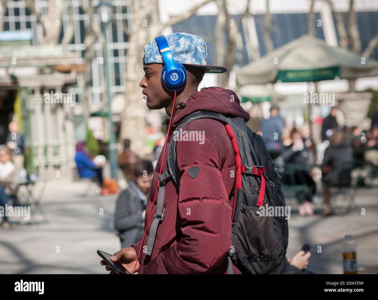 A visitor to Bryant Park wears his Beats by Dr. Dre headphones as he walks through the park in New York Stock Photo