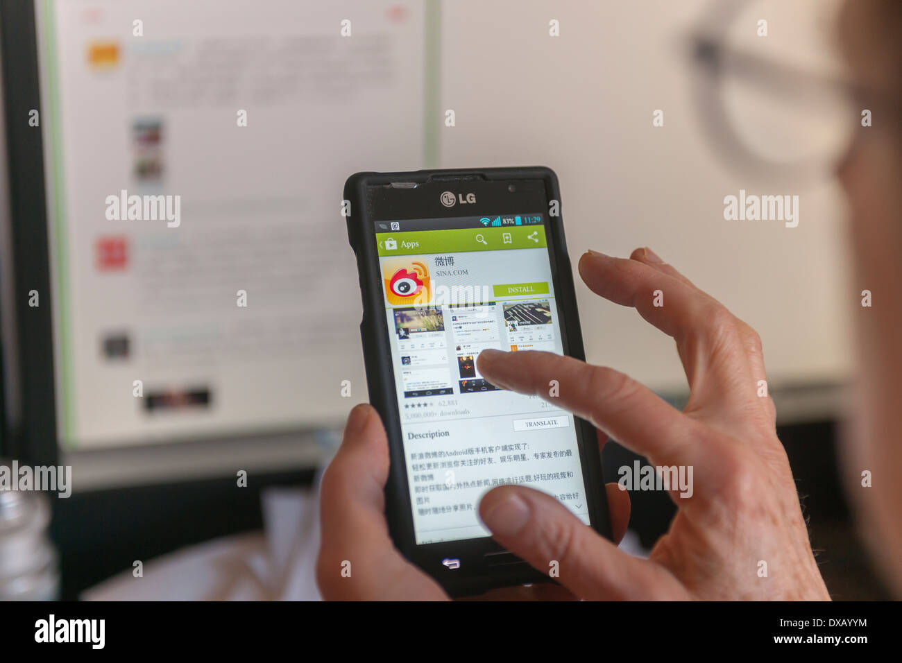 A woman prepares to load the Weibo app on her smartphone in New York Stock Photo