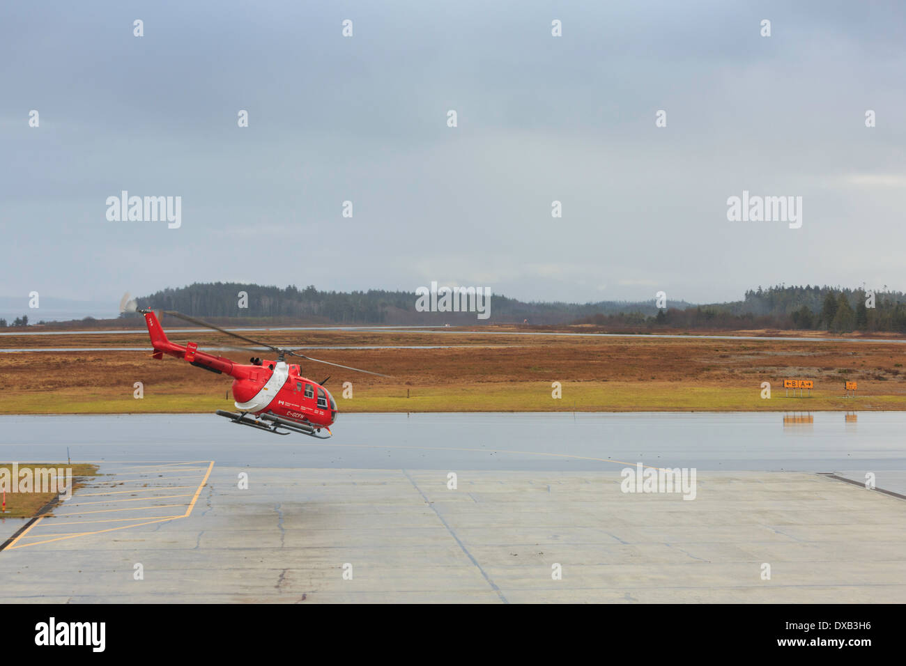 A Canadian Coast Guard helicopter lifts off at Port Hardy Airport in British Columbia Canada. Stock Photo