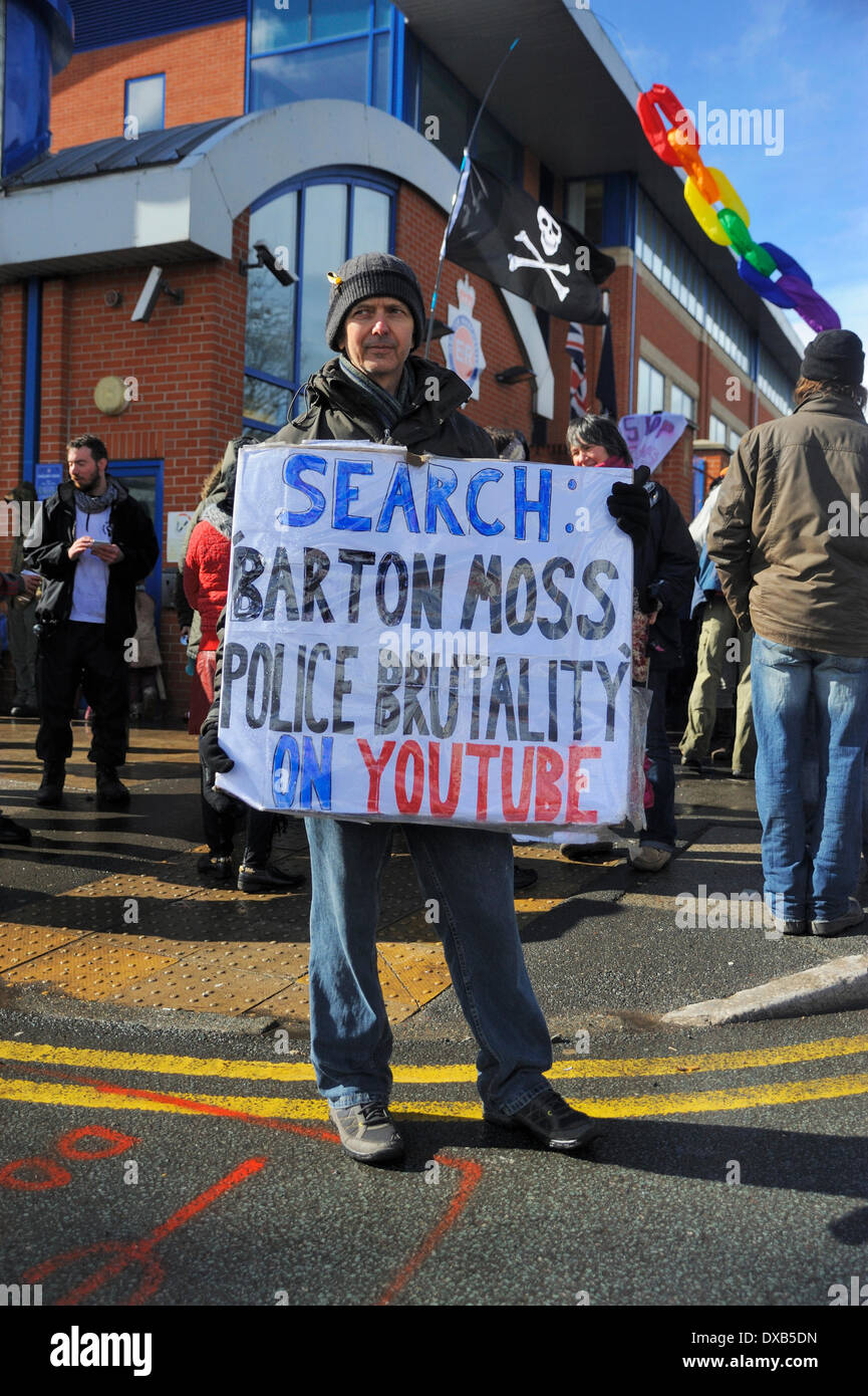 Swinton, Salford, Manchester, UK . 22nd March 2014. Anti-fracking campaigners protest outside Swinton police station, Salford, Manchester. Protester holding his sign about police brtality in front of the protesters at Swinton police station. Credit:  Dave Ellison/Alamy Live News Stock Photo