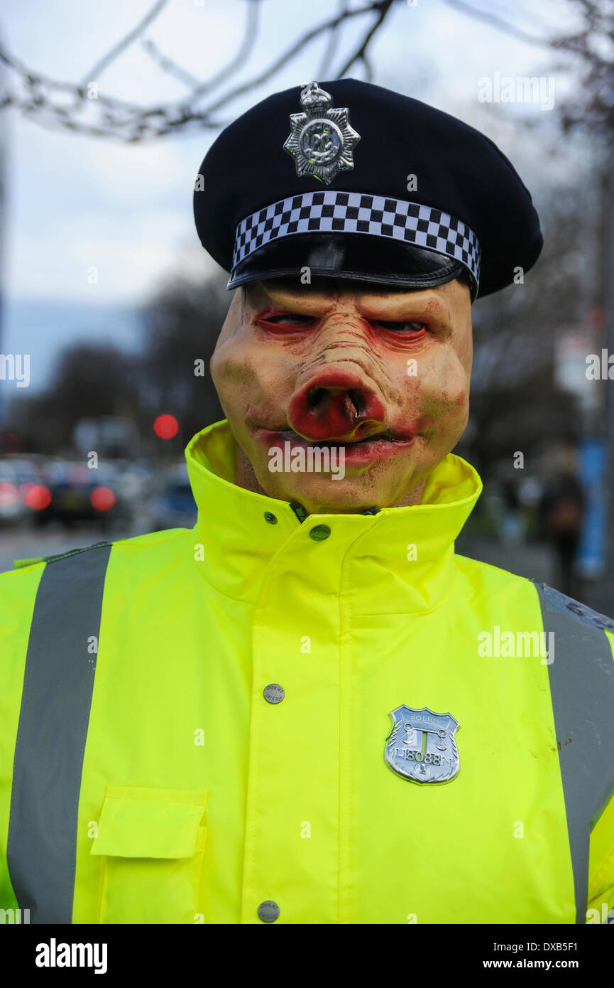 Swinton, Salford, Manchester, UK . 22nd March 2014. Anti-fracking campaigners protest outside Swinton police station, Salford, Manchester. Protester dressed as a policeman wearing a pig mask Credit:  Dave Ellison/Alamy Live News Stock Photo