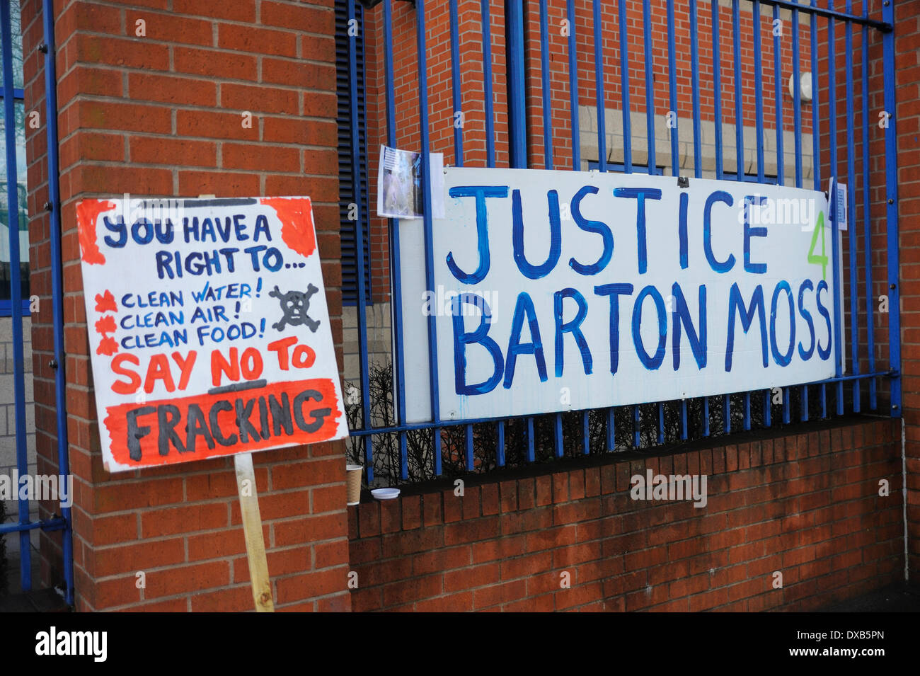 Swinton, Salford, Manchester, UK . 22nd March 2014. Anti-fracking campaigners protest outside Swinton police station, Salford, Manchester. Anti-fracking sign next to a justice 4 Barton Moss sign. Credit:  Dave Ellison/Alamy Live News Stock Photo