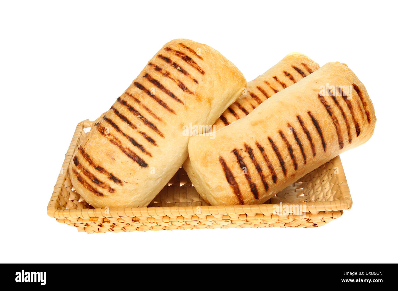 Panini bread rolls in a wicker basket isolated against white Stock Photo