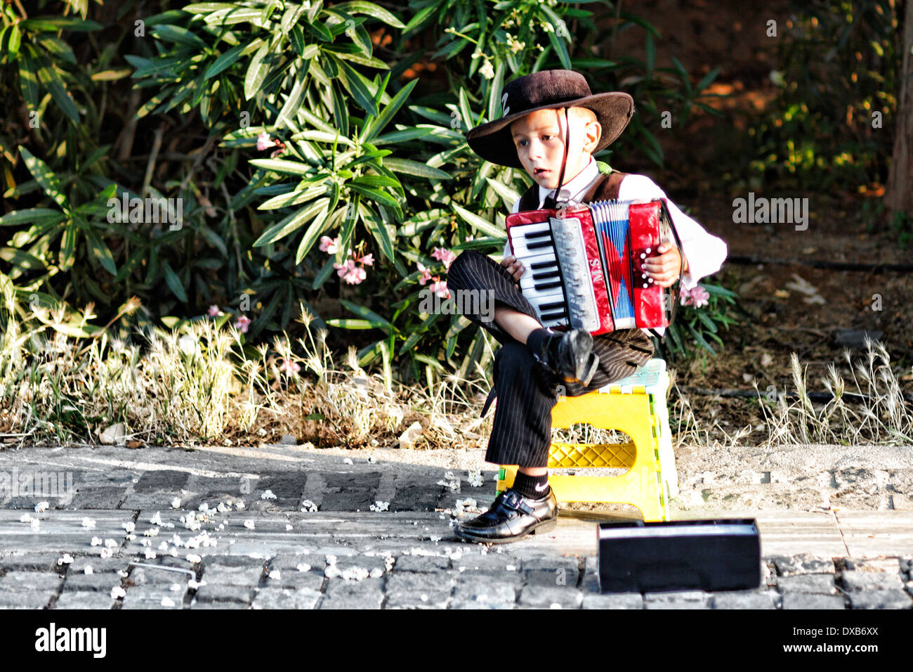 A kid playing accordion in the street of Athens, Greece Stock Photo