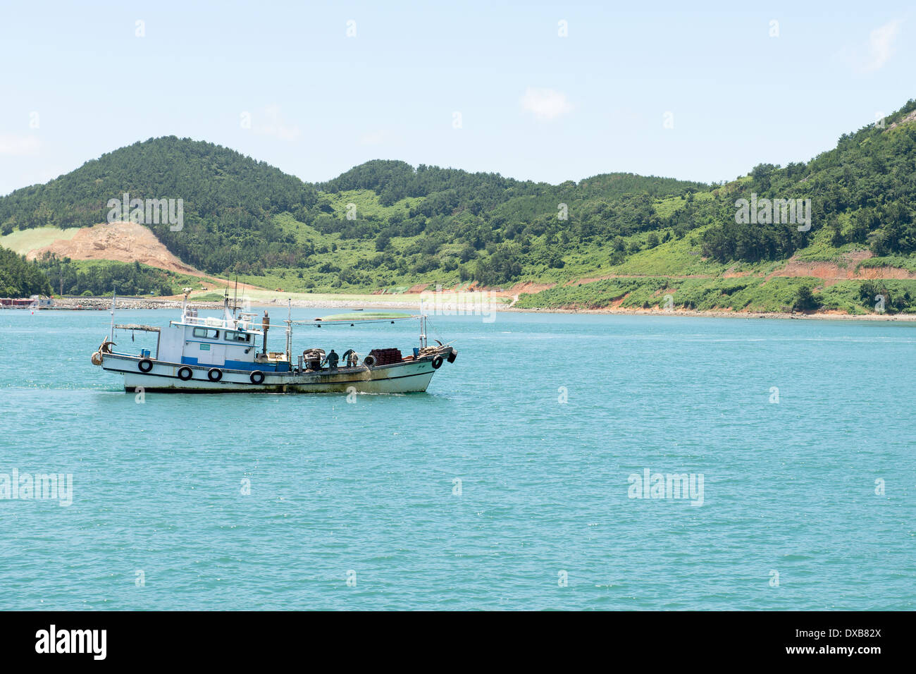 Typical small fishing boat in South Korea with people on board and ...