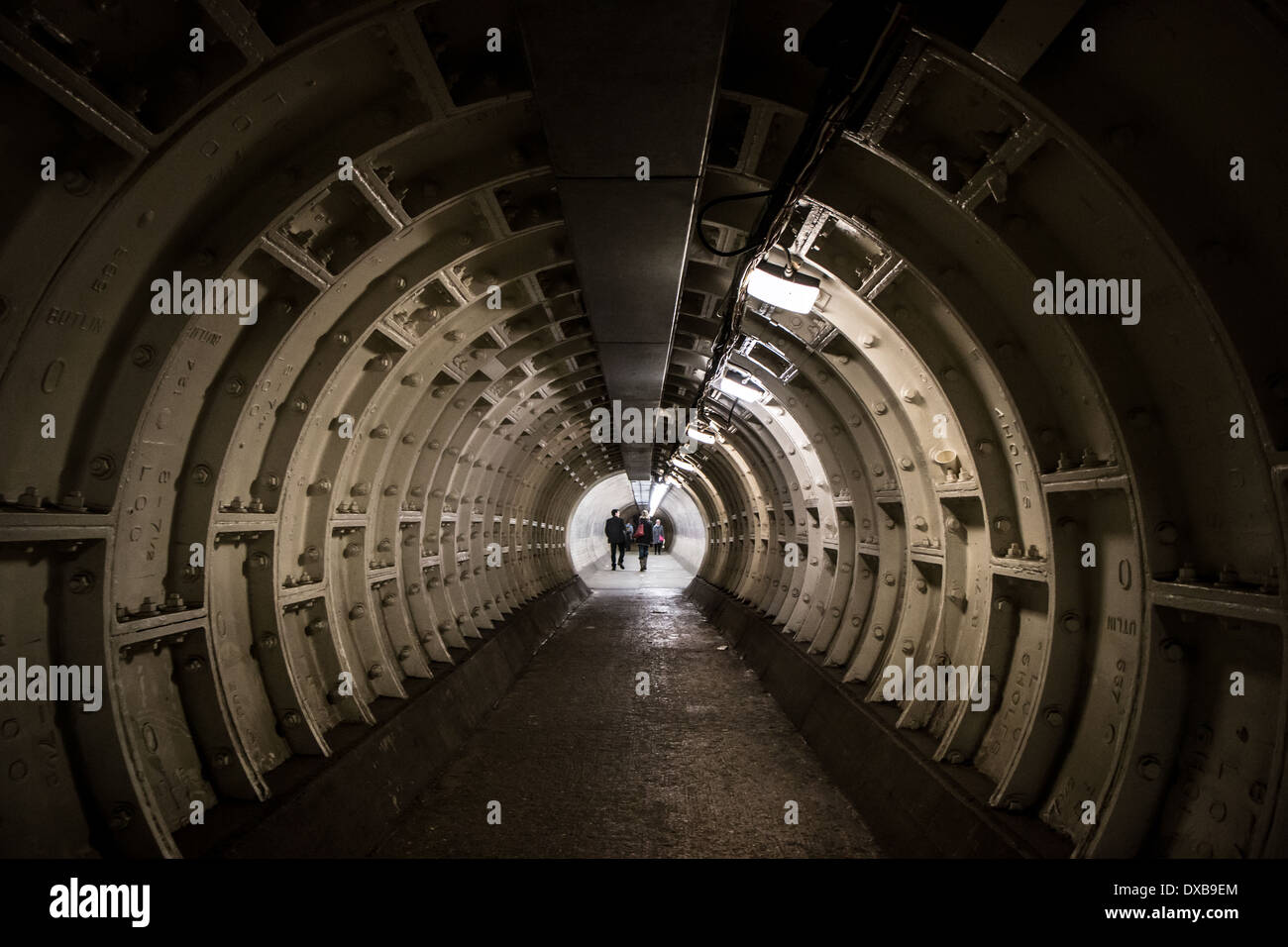 Dark tunnel with people in the distance, Stock Photo