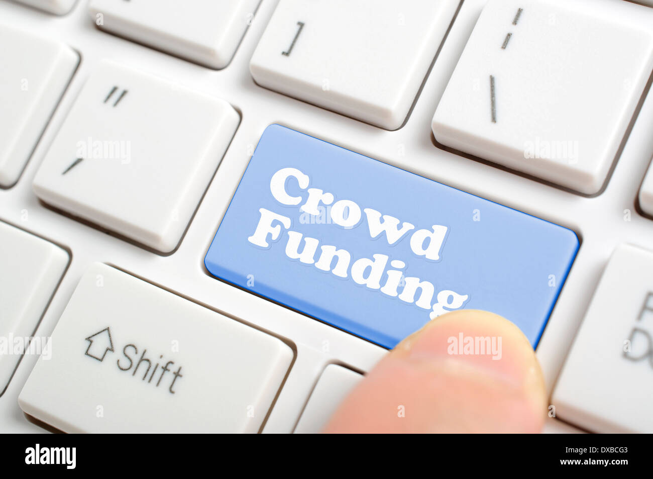 Pressing crowd funding key on keyboard Stock Photo