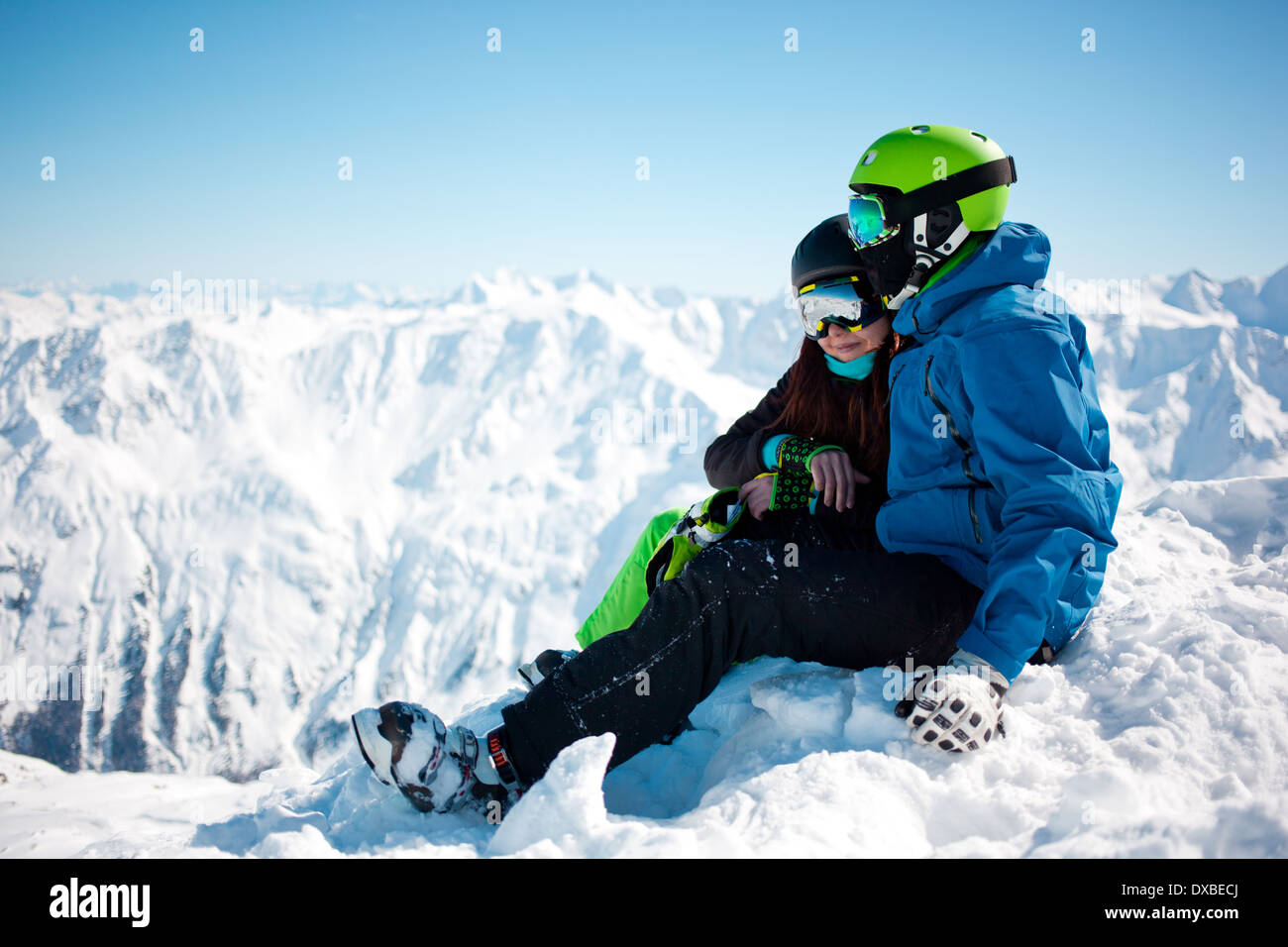 Young happy couple in snowy mountains Stock Photo - Alamy