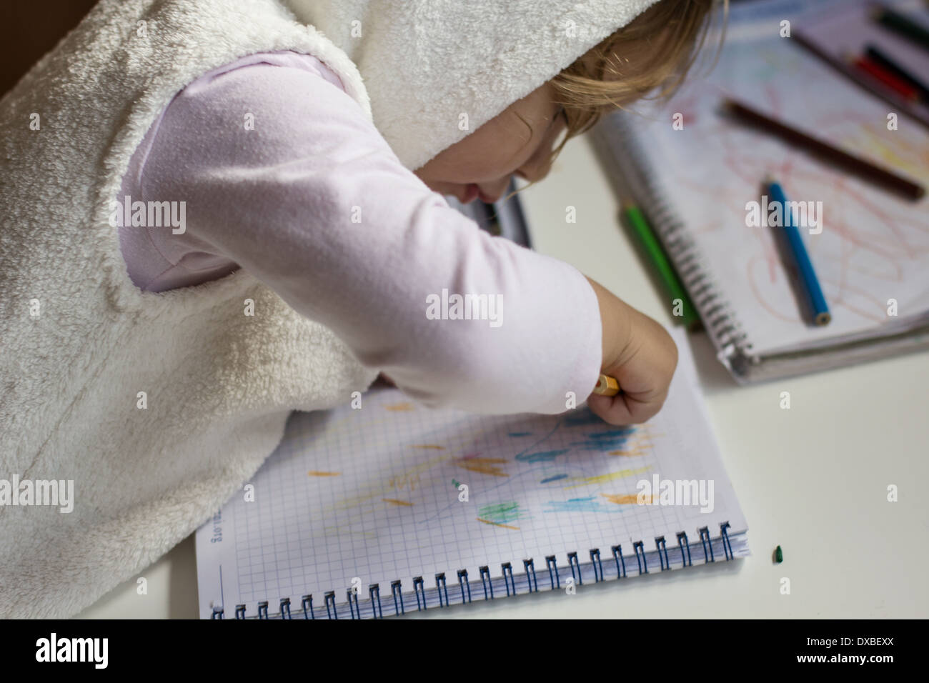 Little girl drawing with colored pencils at home Stock Photo - Alamy