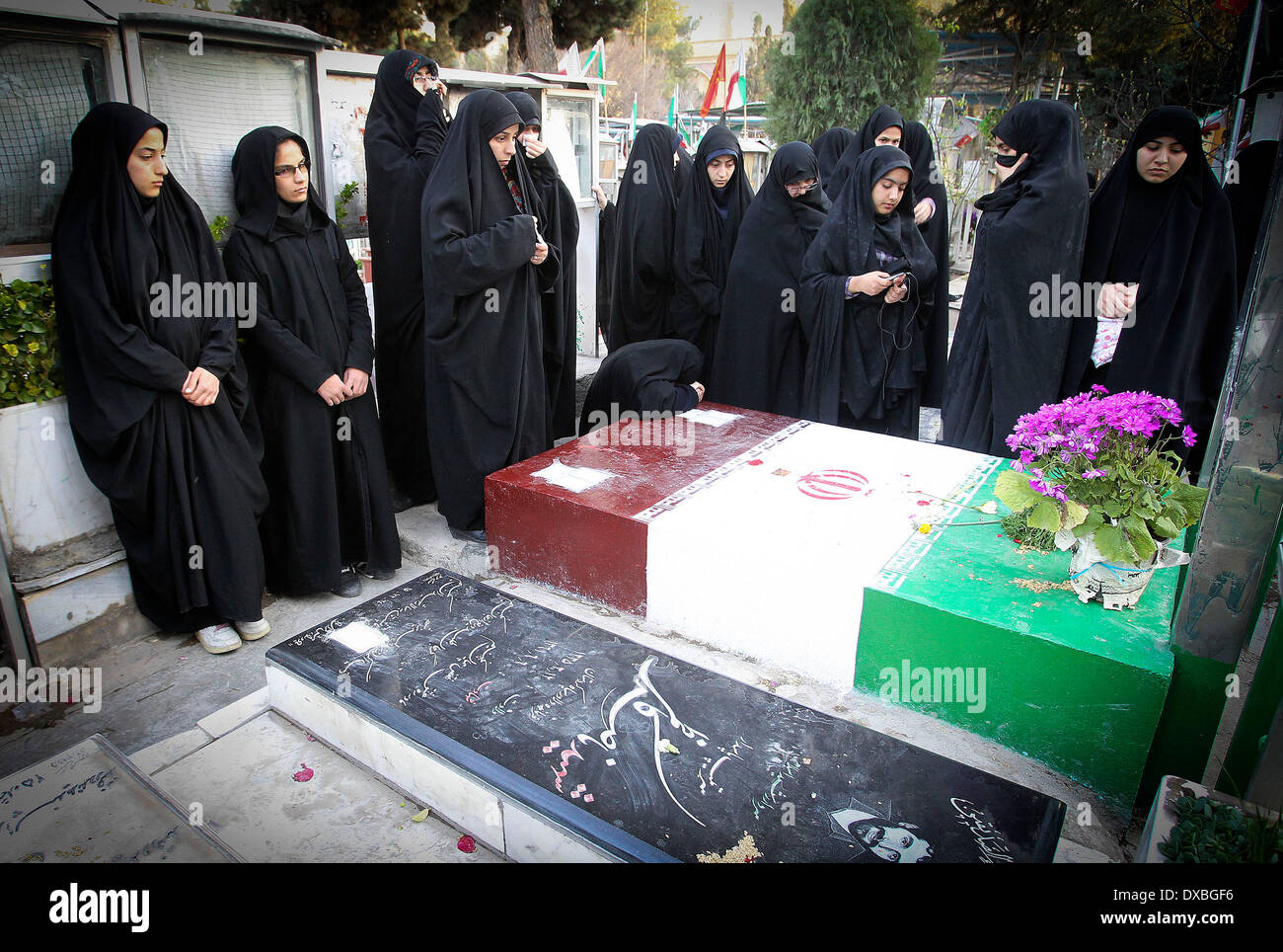 Tehran, Iran. 22nd Mar, 2014. Iranian women pay respect at the cemetery of soldiers who were killed during the 1980-88 Iran-Iraq war, in Tehran, Iran, March 22, 2014. Credit:  Ahmad Halabisaz/Xinhua/Alamy Live News Stock Photo