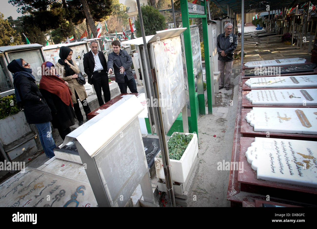 Tehran, Iran. 22nd Mar, 2014. Iranian people pay respect at the cemetery of soldiers who were killed during the 1980-88 Iran-Iraq war, in Tehran, Iran, March 22, 2014. Credit:  Ahmad Halabisaz/Xinhua/Alamy Live News Stock Photo