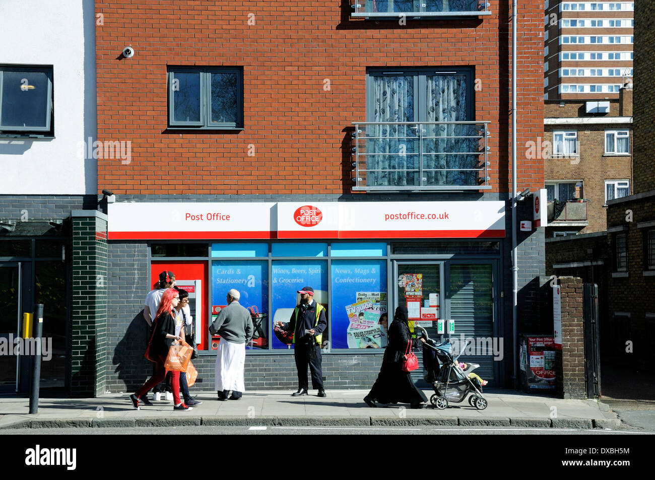Post Office with people passing, Burdett Road, Mile End, London Borough of Tower Hamlets, England UK Stock Photo