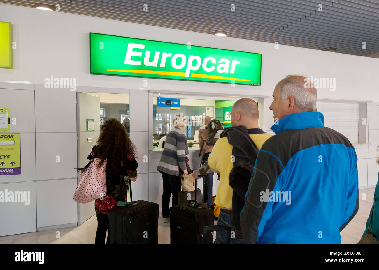 People waiting in a queue at the Europcar rental hire car desk counter, Almeria airport, Spain Europe Stock Photo