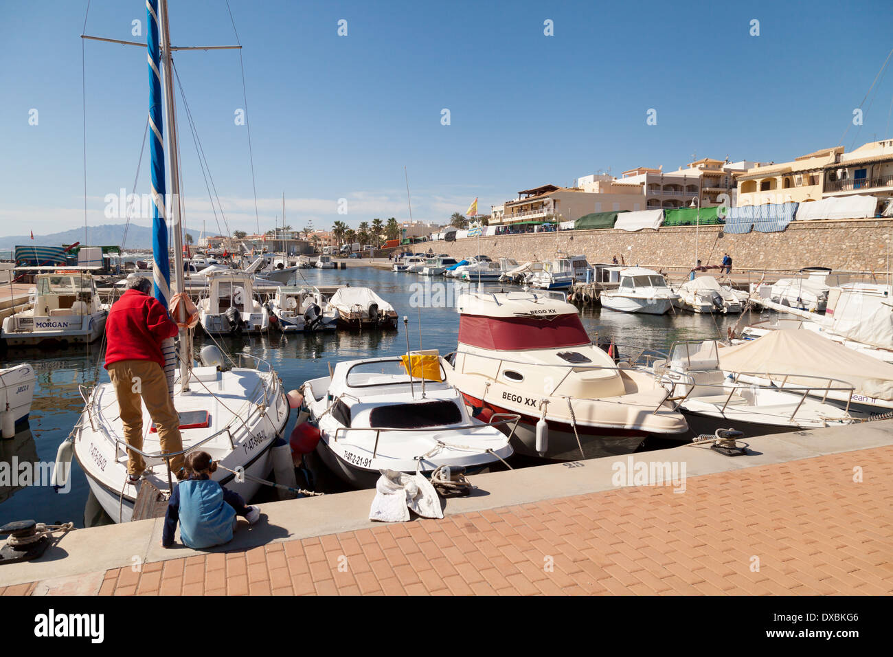 A family preparing their yacht in the marina harbour, Villaricos village, Almeria, Andalusia, Mediterranean coast, Spain Stock Photo