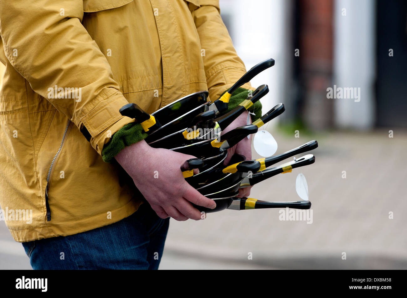 Man carrying pancake race frying pans Stock Photo