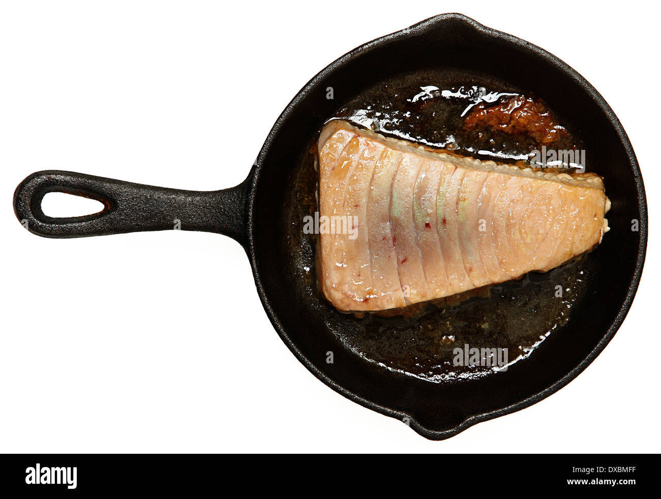 Fresh Oven Baked Sashimi Tuna in cast iron skillet over white. Stock Photo