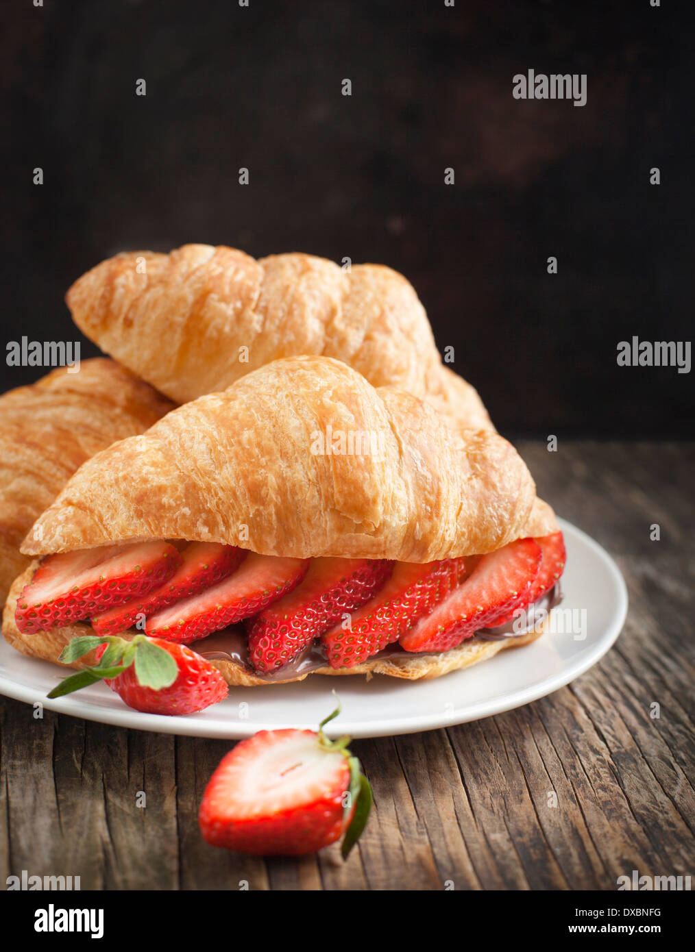 Fresh croissants with strawberry and chocolate nuts cream Stock Photo