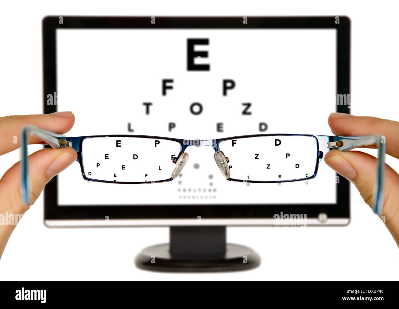 Man is viewing to eye examination chart on display through eyeglasses Stock Photo