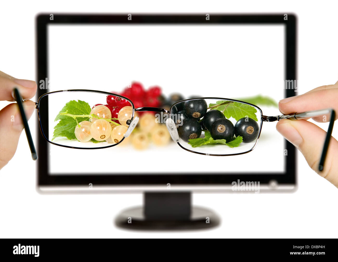 Man is viewing to currants with leaves on display through eyeglasses Stock Photo