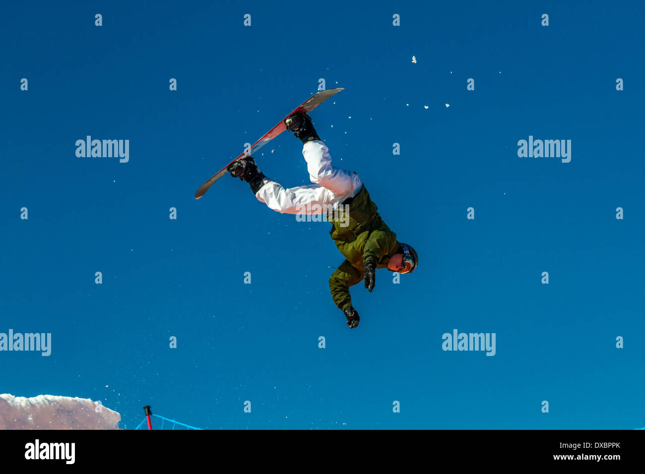 Airborne snowboarder about to land in a heap on a giant airbag Stock Photo