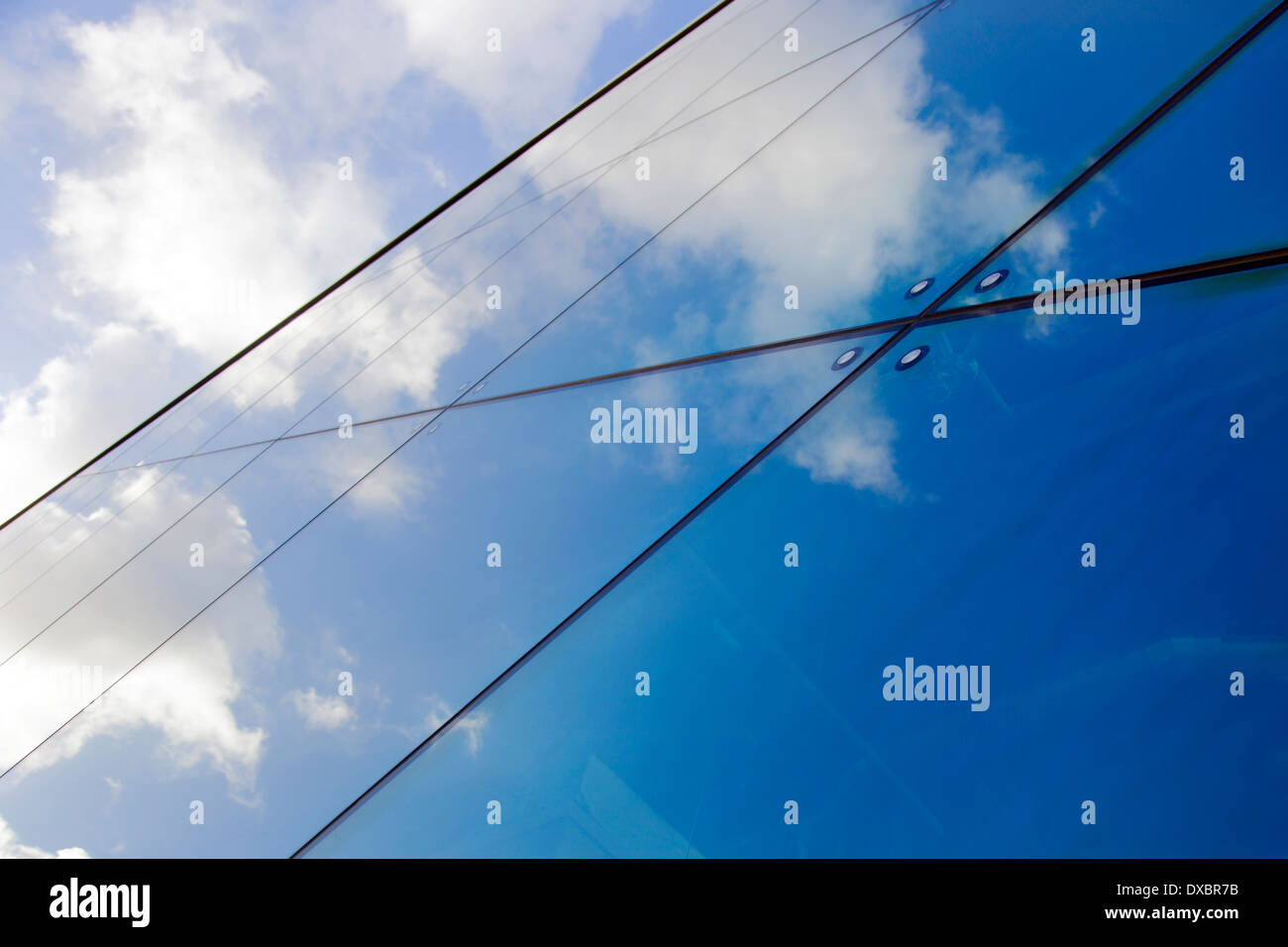 reflections of clouds and blue sky in modern glass facade Stock Photo ...