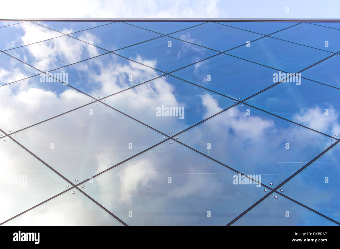 reflexions of clouds and blue sky in glass facade of modern building ...