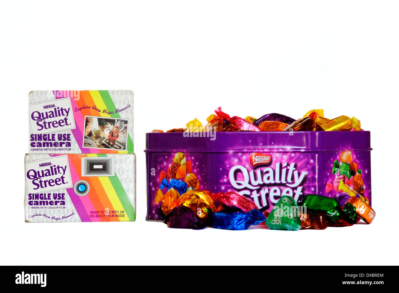 tin of quality street chocolates with an old disposal camera given away as a free promotion Stock Photo