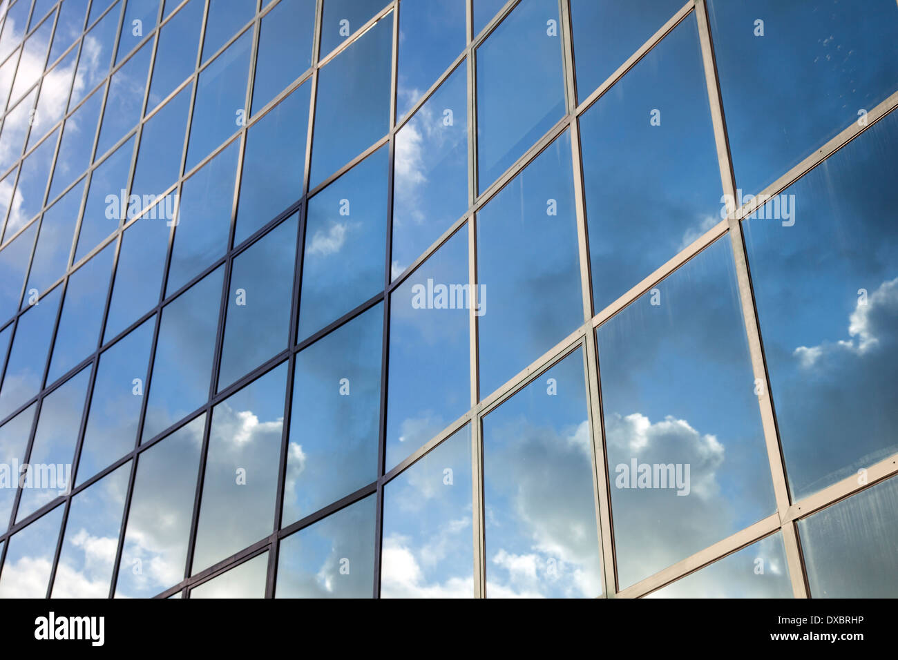 reflexions of clouds and blue sky in glass facade of modern building ...