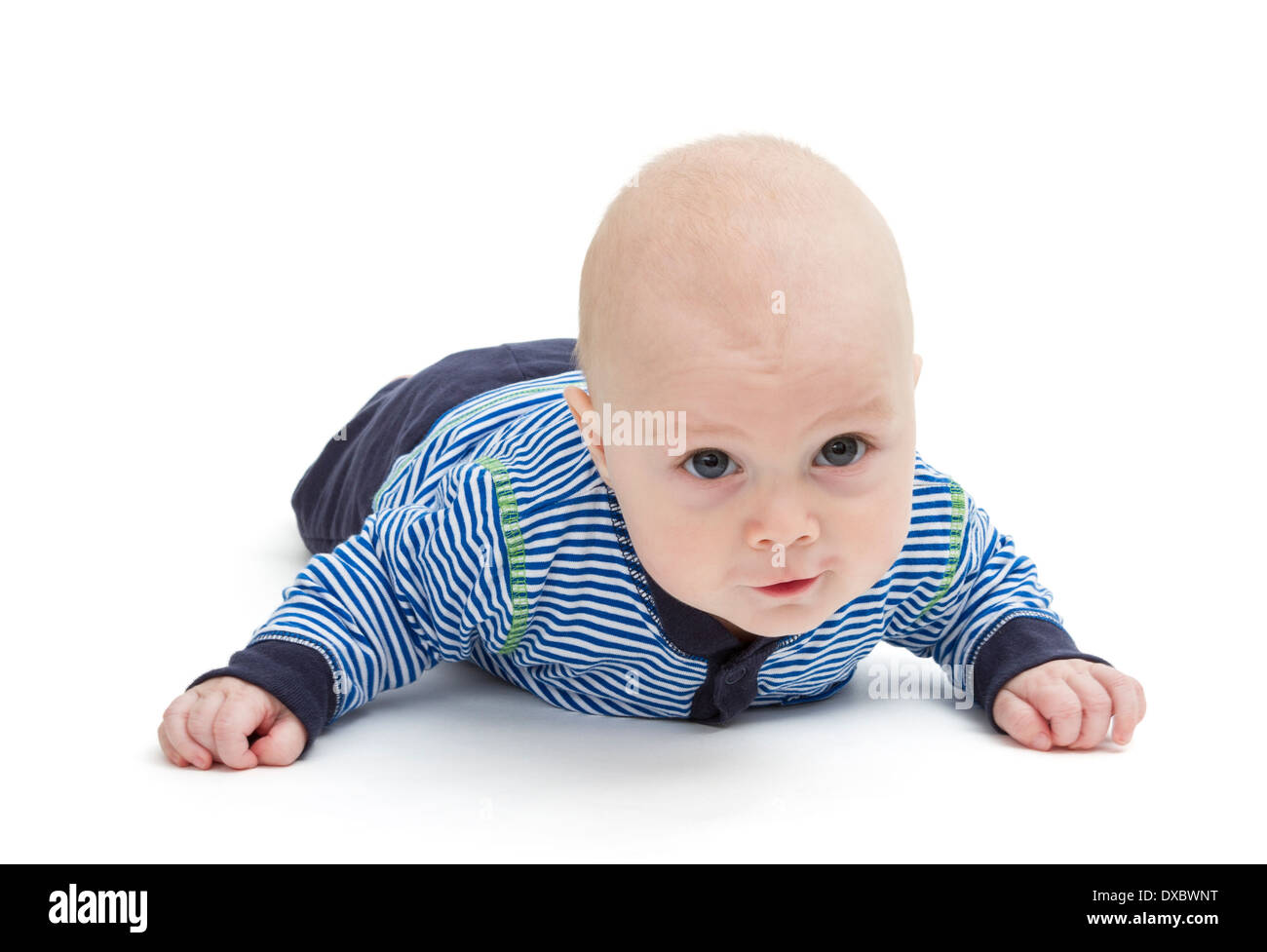 attentive baby laying on ground isolated on white background Stock Photo