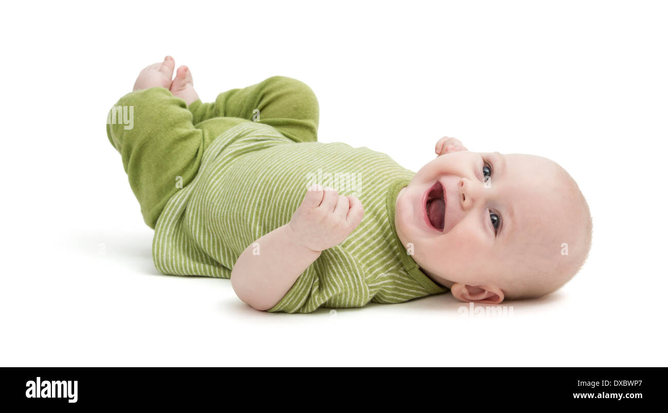 happy baby in green clothing lying on his back. isolated on white background Stock Photo