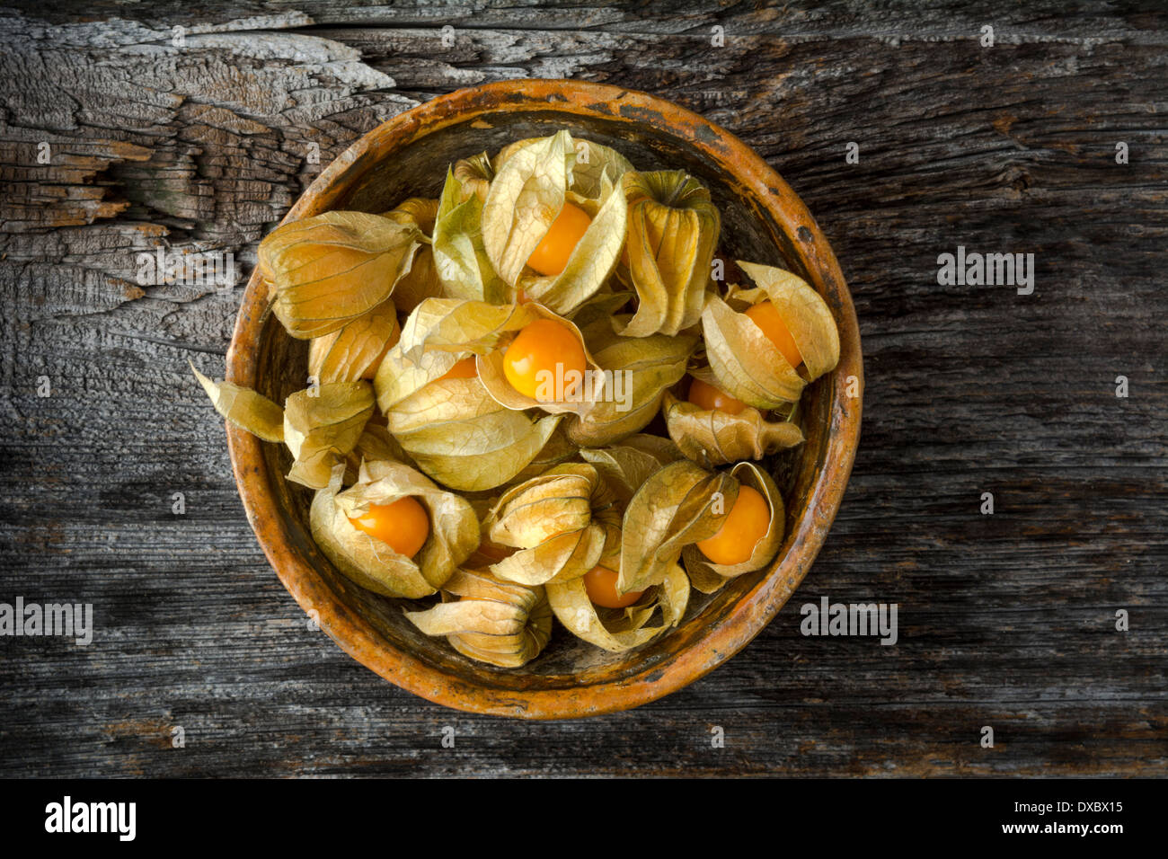 Gooseberries in Bowl on Rustic Wood shot from above Stock Photo