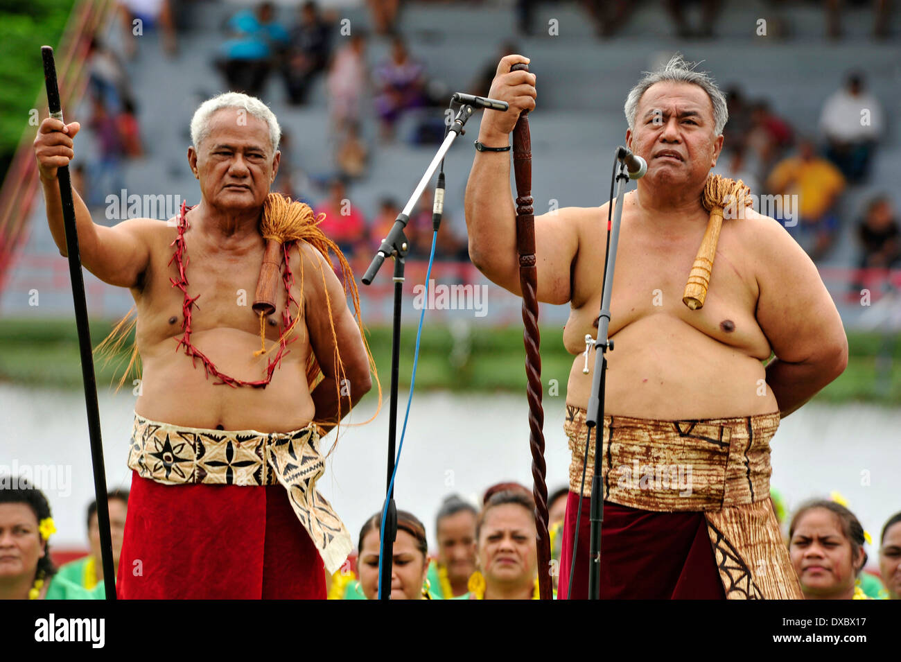 American Samoa Governor Togiola Tulafono, left, dressed in traditional Samoan lava-lava while a matai speaks for the high chief during Flag Day celebrations at Veterans Memorial Stadium April 18, 2010 in Tafuna, American Samoa. Stock Photo