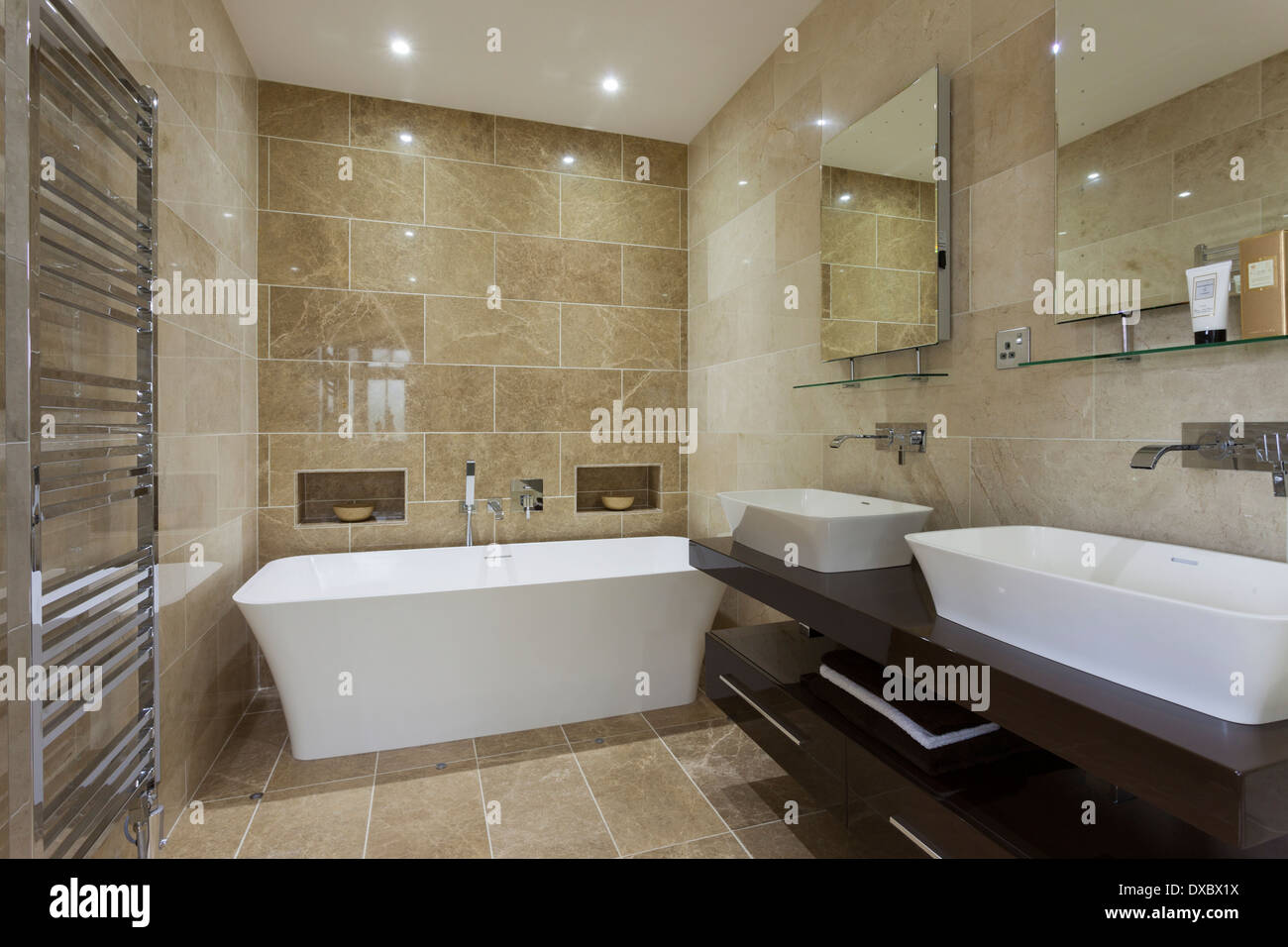 Luxury bathroom with Mandarin Stone tiling and floor Stock Photo