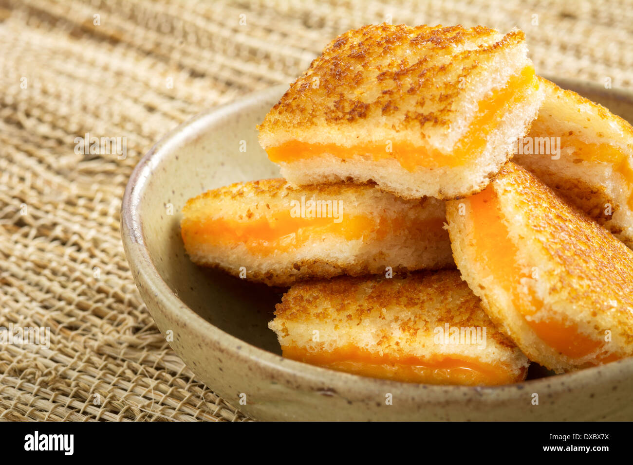 Bowl of mini grilled cheese appetizers with cheddar cheese Stock Photo