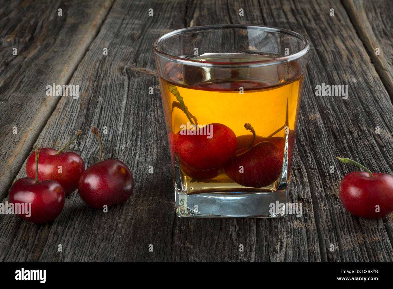 Manhattan or other whiskey cocktail, with cherries submerged and cherries next to it Stock Photo