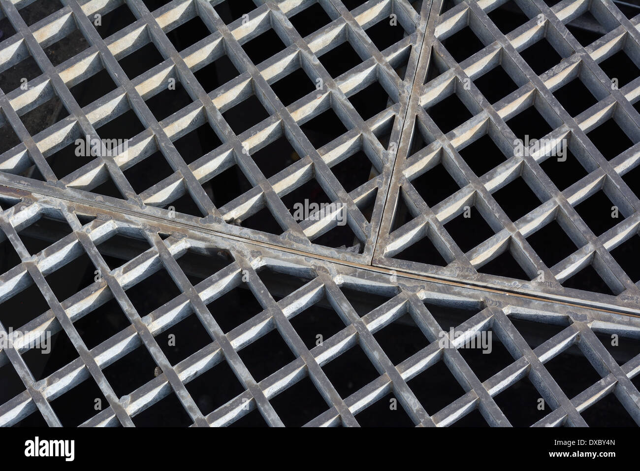 Metal Sewer Grate as Part of Urban Infrastructure Stock Photo