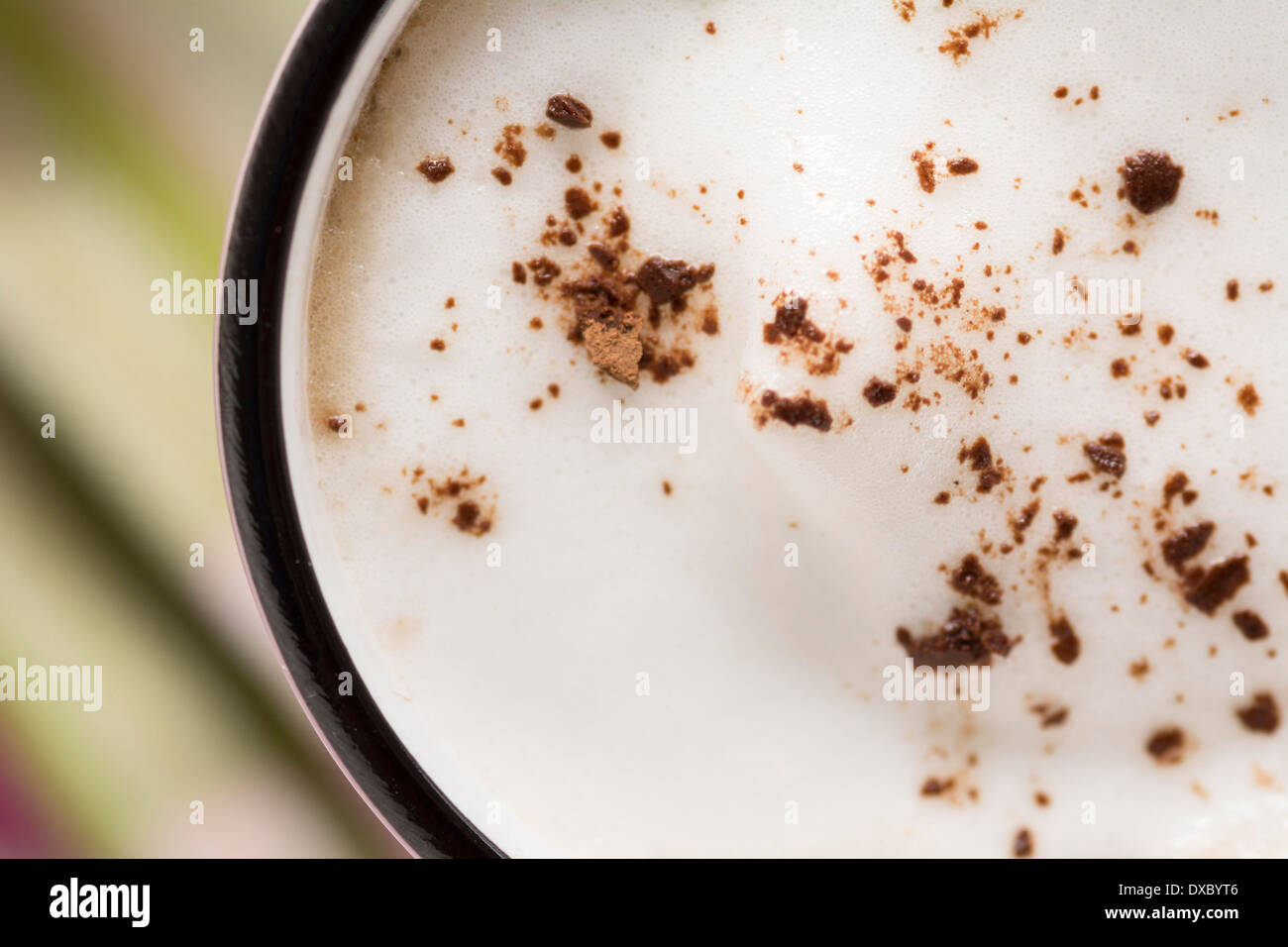 Cappuccino in pink cup with cocoa and almond milk foam Stock Photo