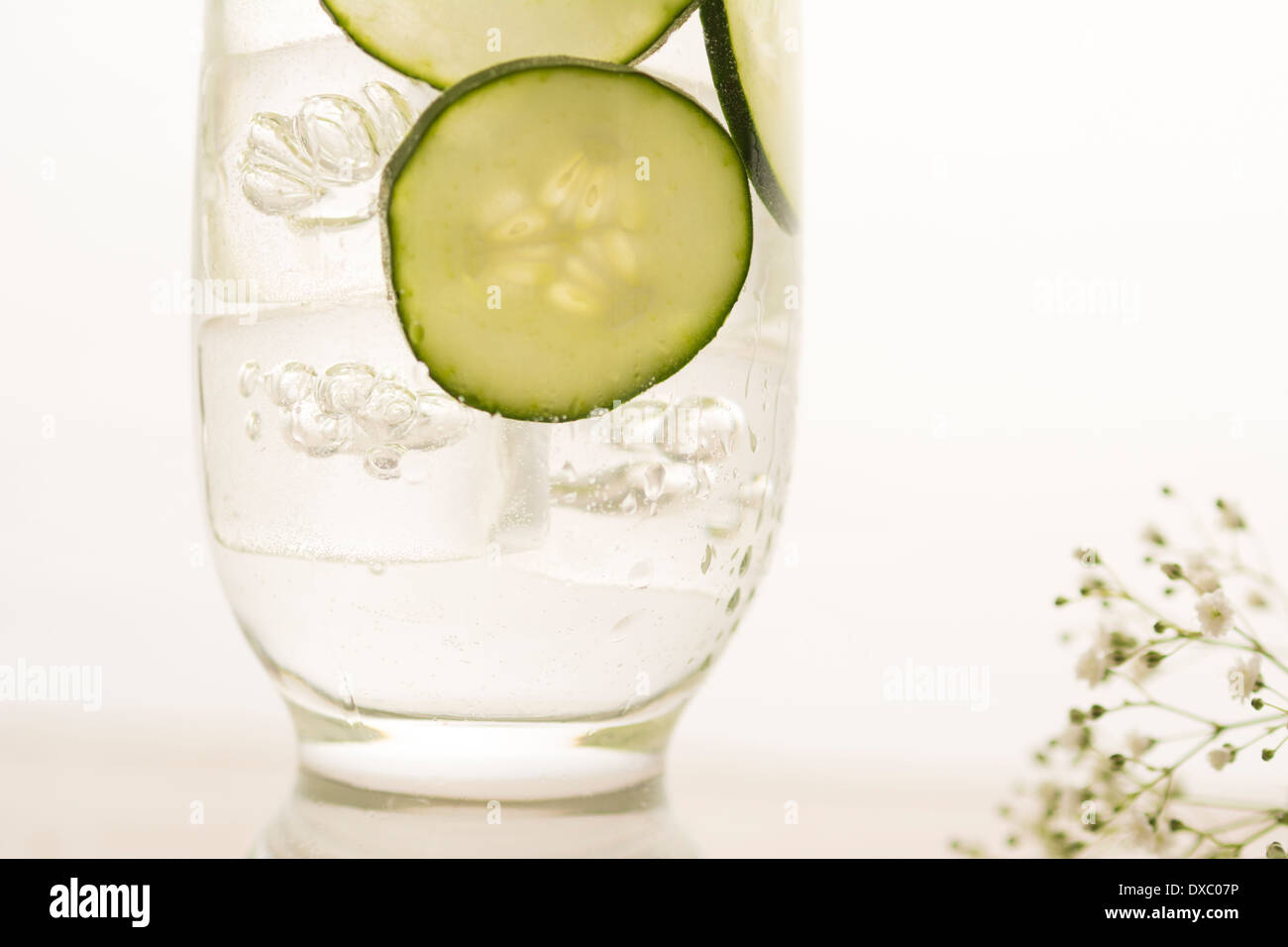 Cucumbers in cold water for refreshing summer drink Stock Photo