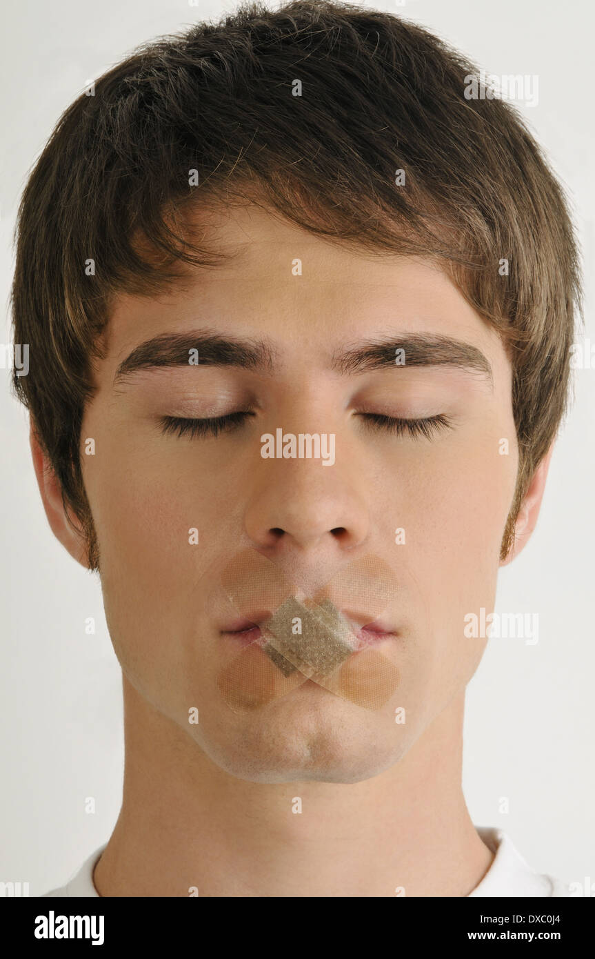 Young male adult, BandAids over mouth Stock Photo Alamy